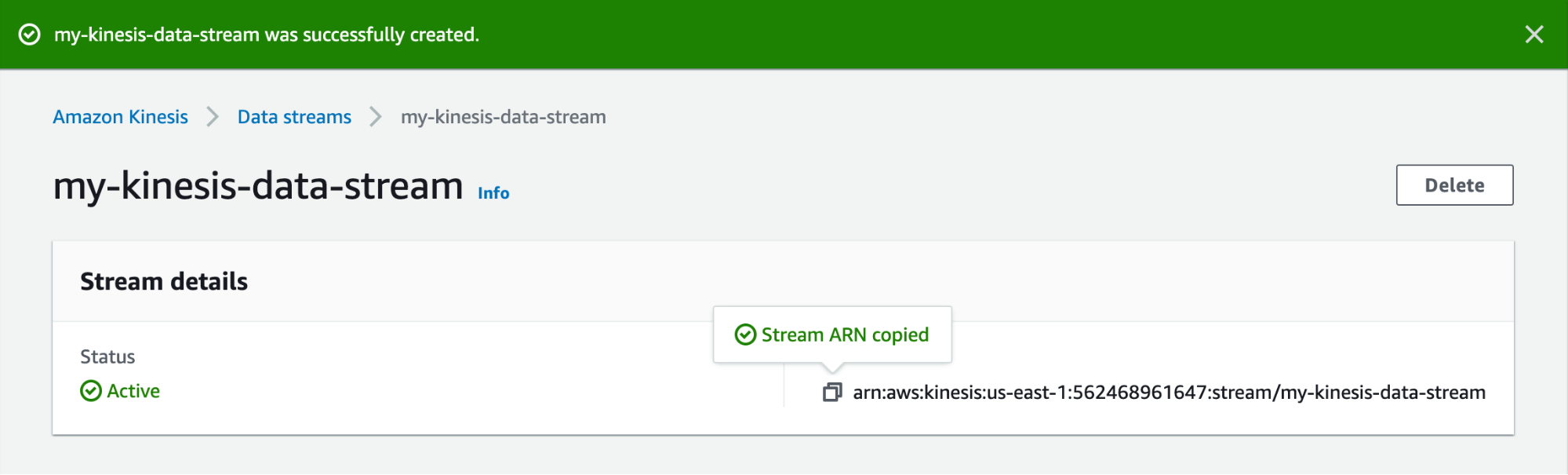 A Kinesis web page shows a banner stating that the stream was successfully created, and acknowledges that that stream's ARN has been copied to the user's clipboard.