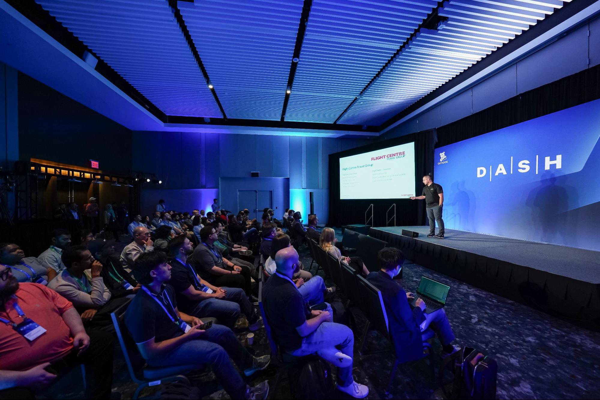 Photo of speaker presenting on stage during a breakout session at DASH 2025.